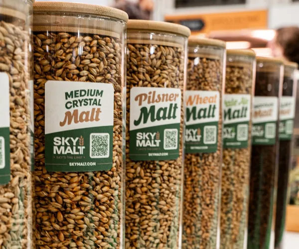 Glass jars of SKY MALT malts, from pale to dark, in a row